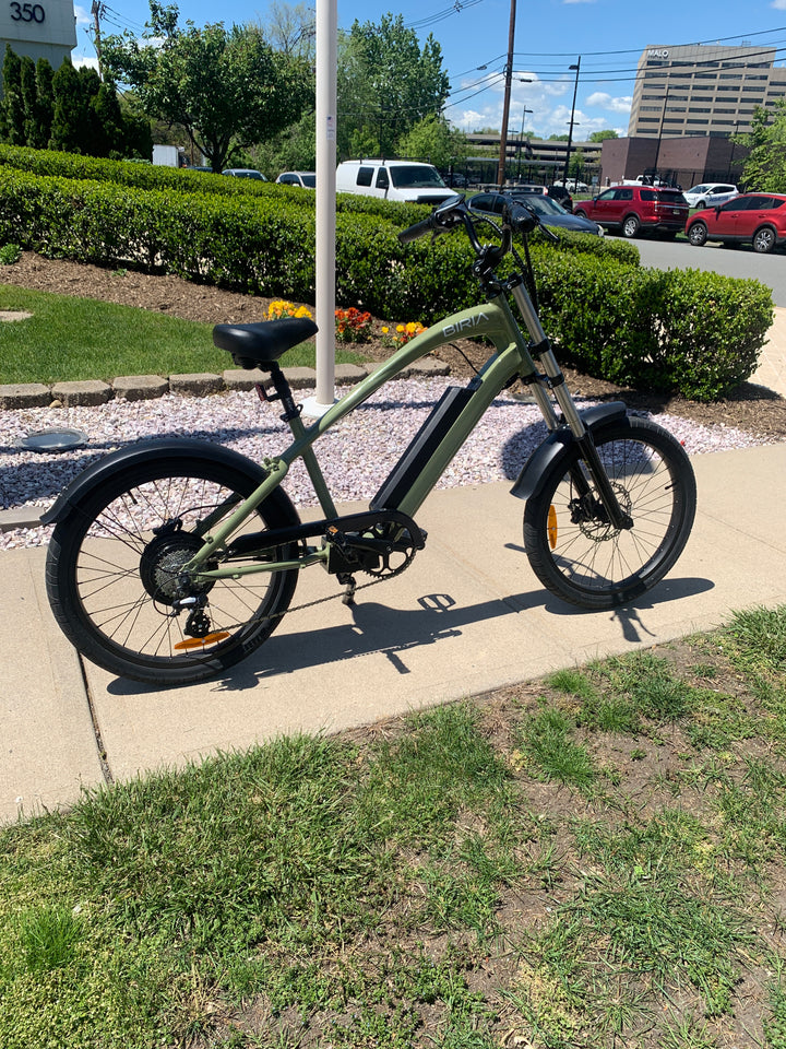 An Electric Chopper bike in front of a flagpole