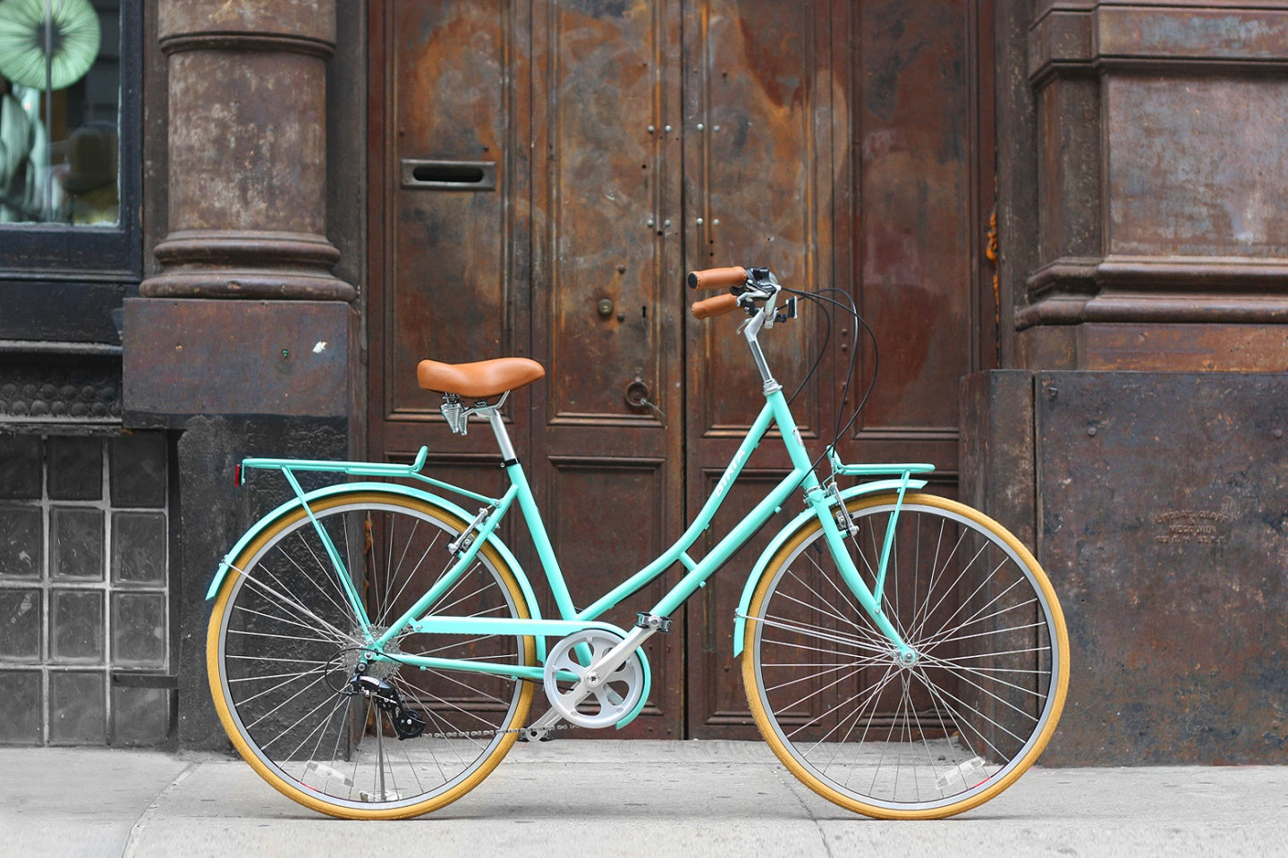 A bicycle in front of a weathered wooden door